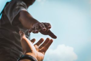 hands reaching to hold each other showing support during crisis care