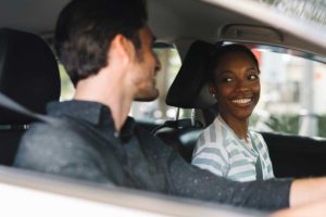 two people in a car using sober transport services