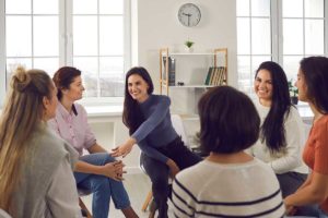 a group of women in group therapy at a womens sober living