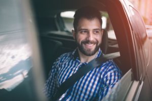 a man sits in the backseat of a car while taking advantage of sober transportation services