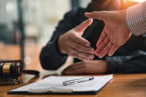 two people are able to shake hands after discovering what is legal aid