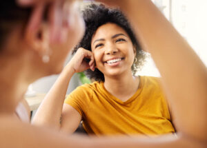 one person is smiling at another after asking them what is sober living