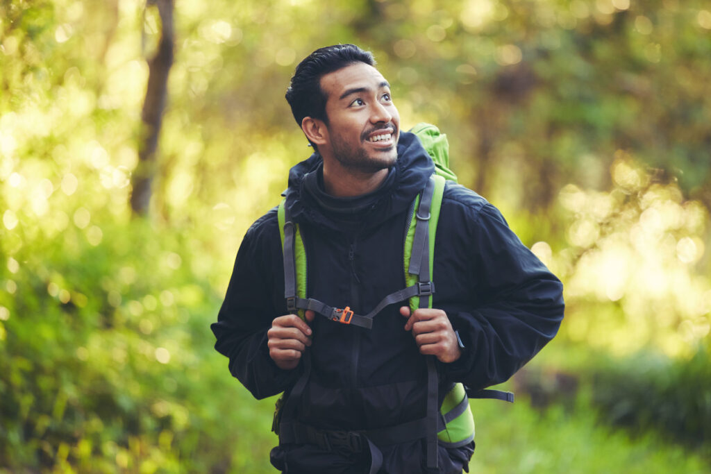 a man reflects on a walk in the woods about how sober living helped him strengthen his recovery goals