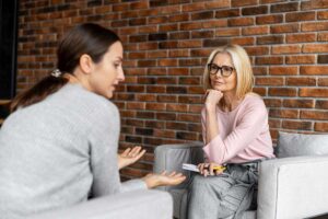 a woman in substance abuse treatment meets with her case manager