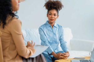 a woman meets with her transitional recovery coach after rehab